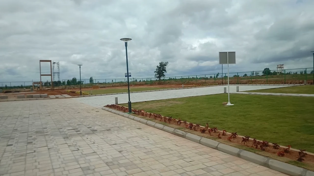 Paved internal road and landscaped verge at the Adarsh Springfield plotted development site, photograph